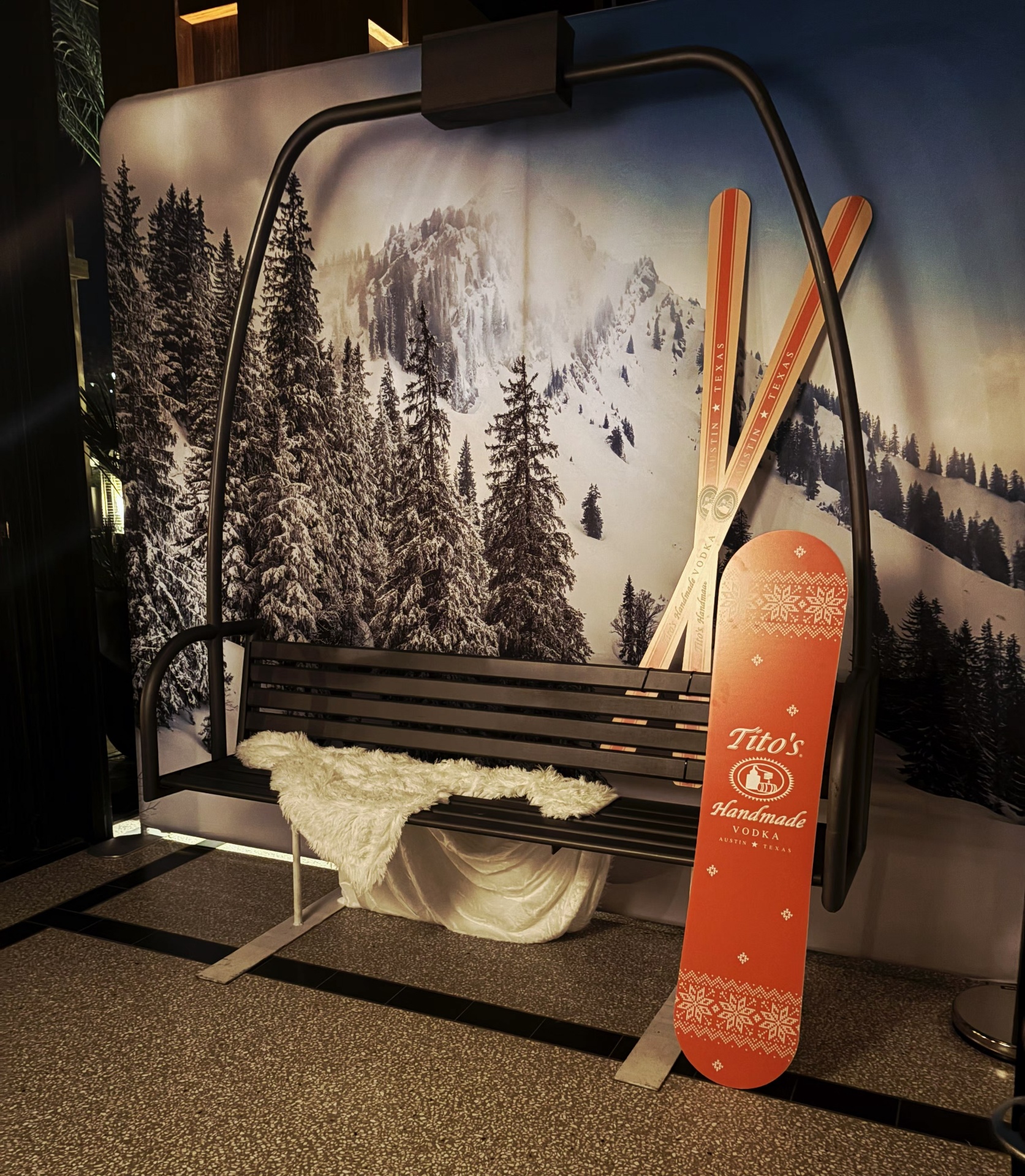 Tito's branded ski lift photo booth with snowy mountain backdrop