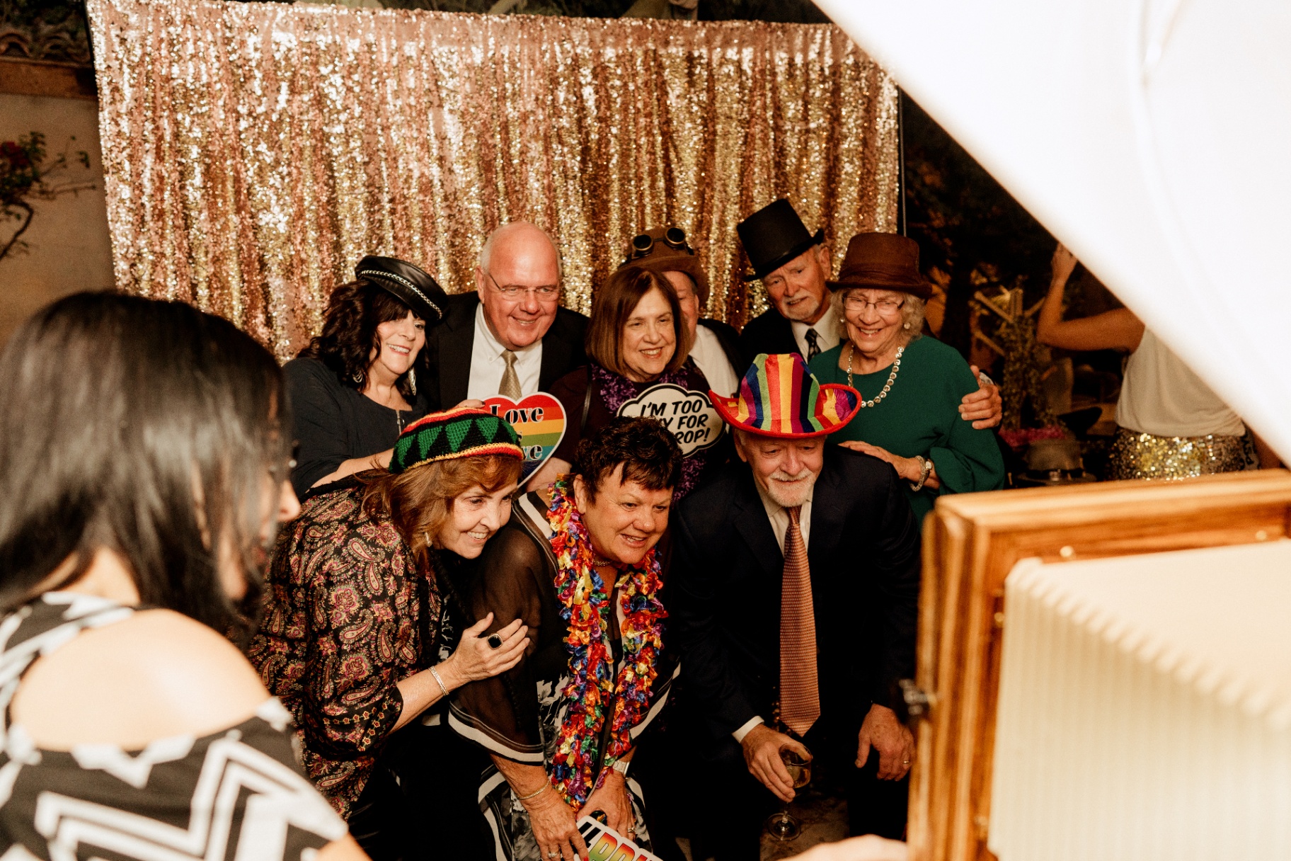 Group of guests laughing with props at a gala photo booth