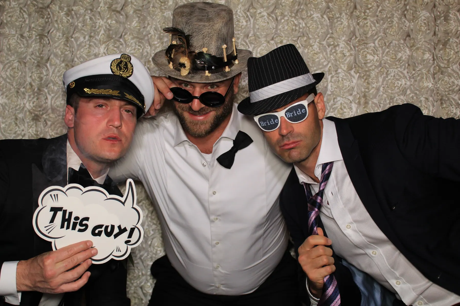 Wedding guests laughing and celebrating together in a photo booth