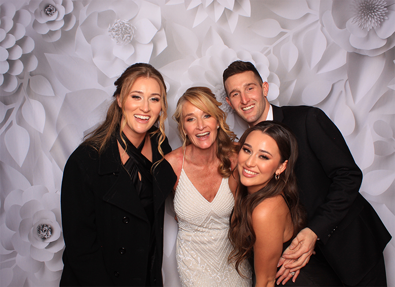 Family portrait with white floral backdrop