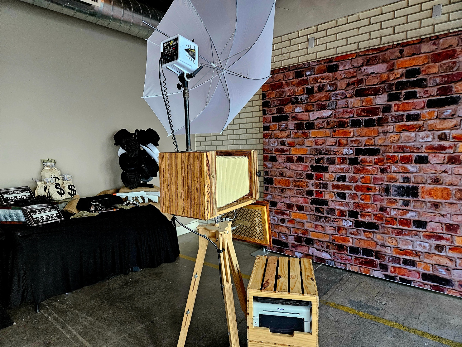 Vintage wooden camera photo booth against a brick backdrop