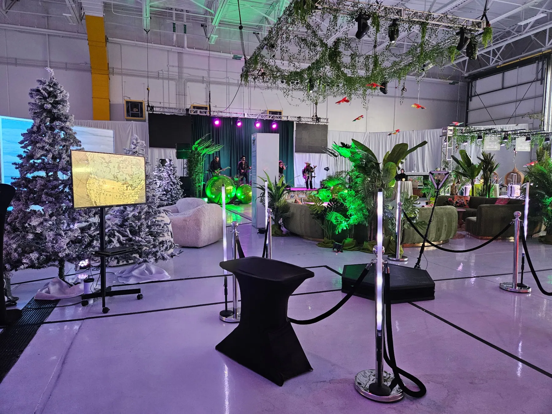 Immersive gala activation with lush greenery, VIP stanchions, and an elegant lounge environment
