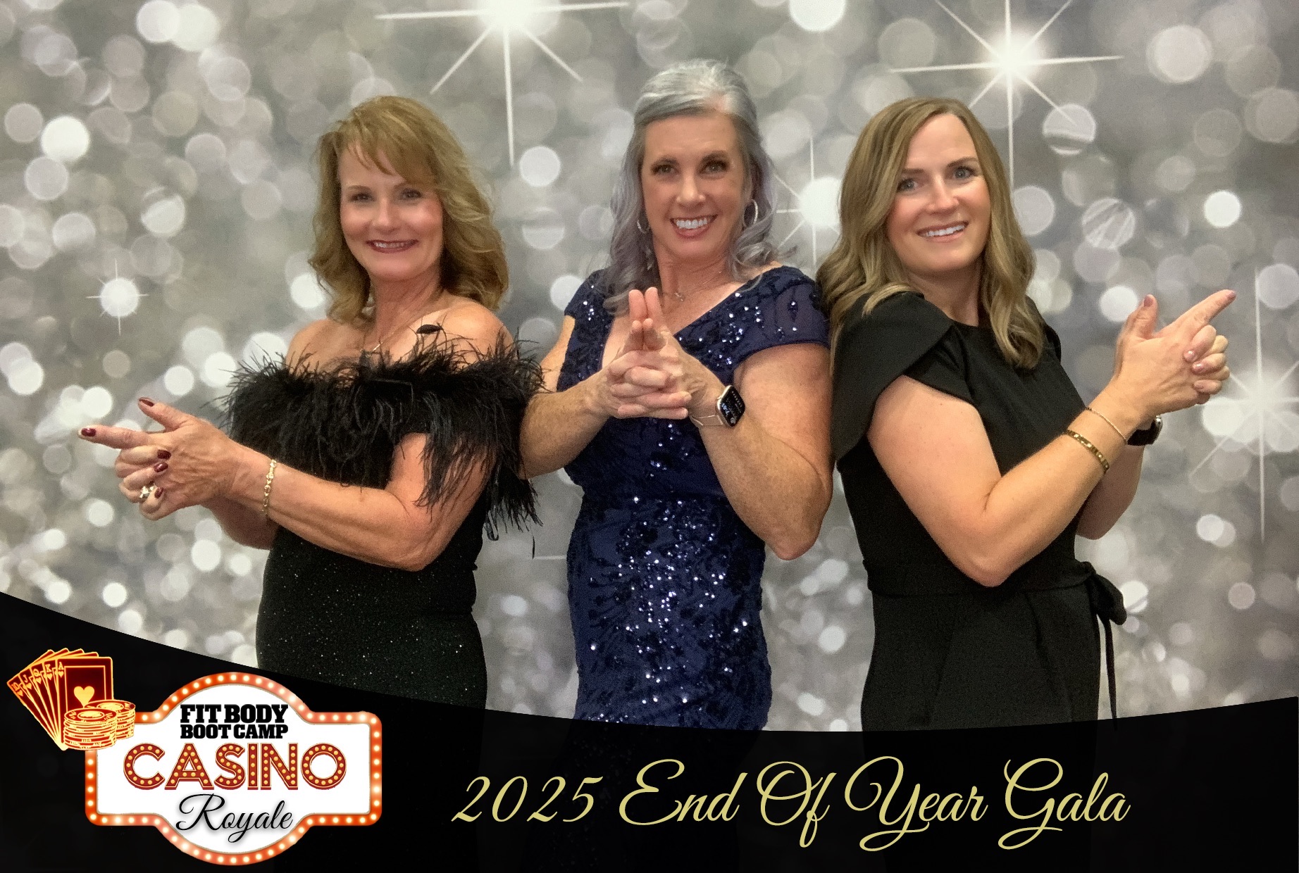 Three women posing in front of a silver sparkle backdrop