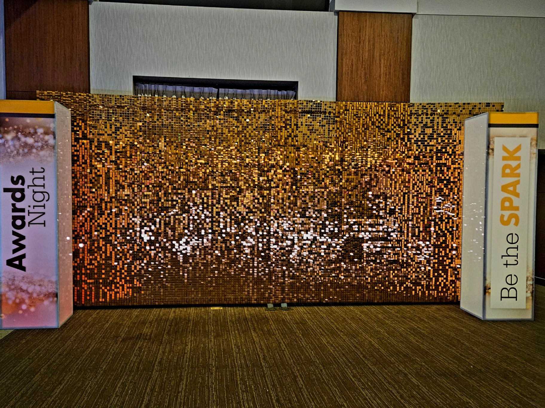 Gold shimmer wall with pillars at an awards night event