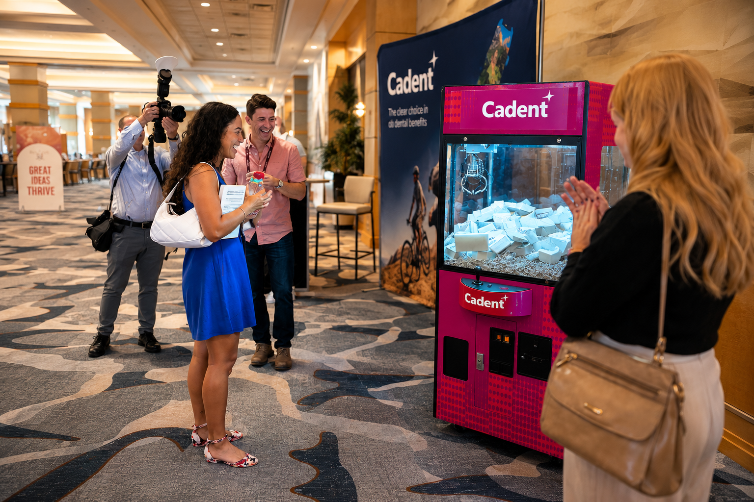Guests gathered around a branded claw machine activation at a trade show