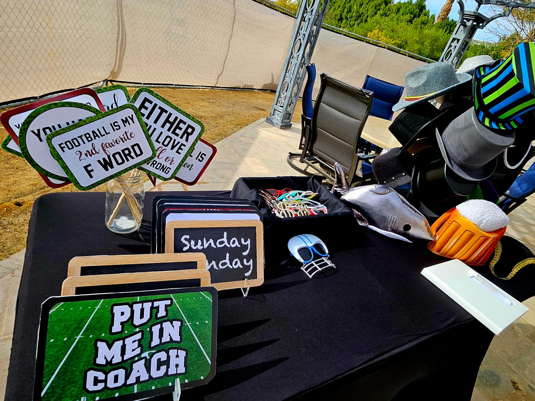 Football-themed prop table at an outdoor event