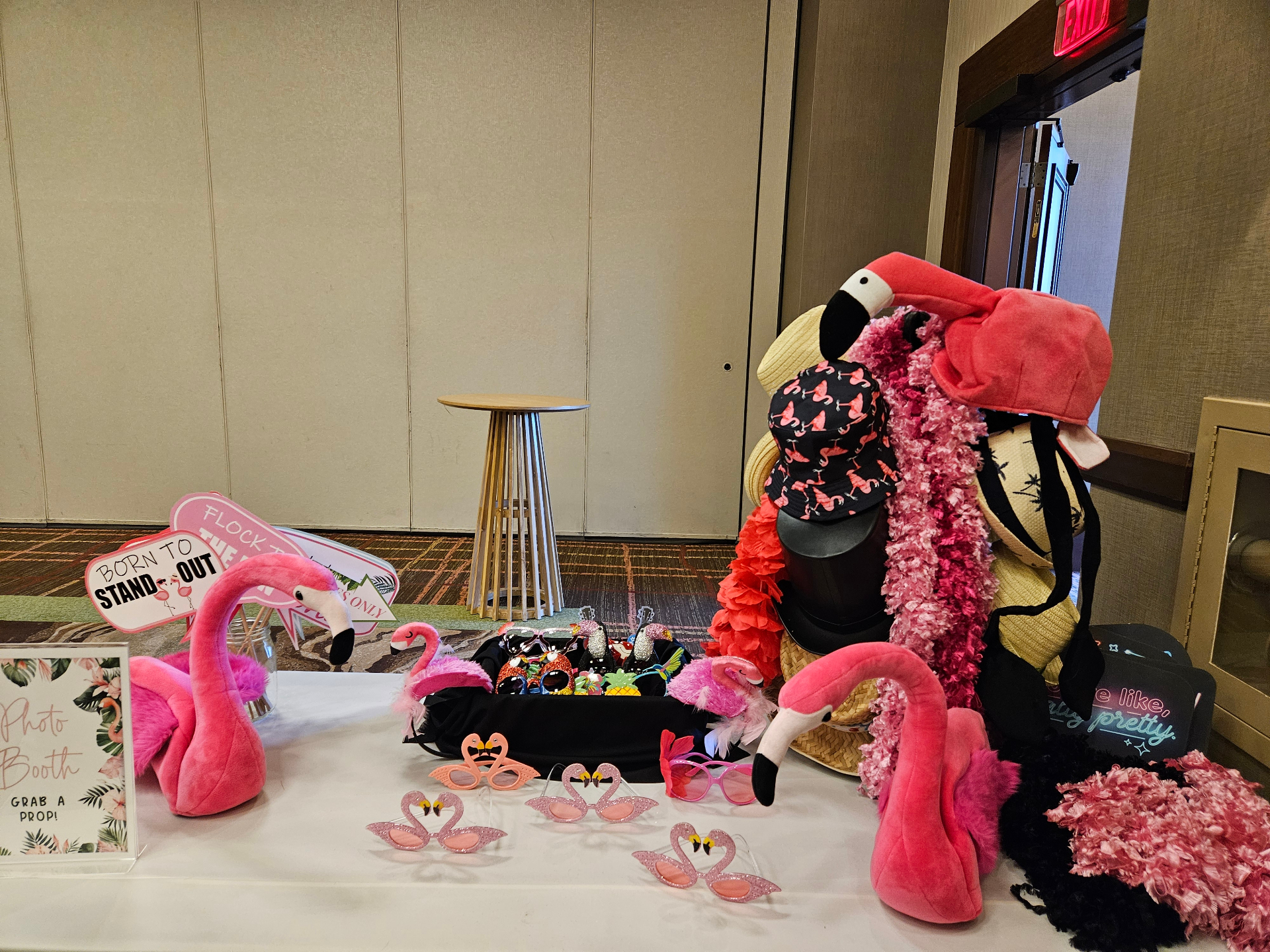 Flamingo-themed photo booth prop table