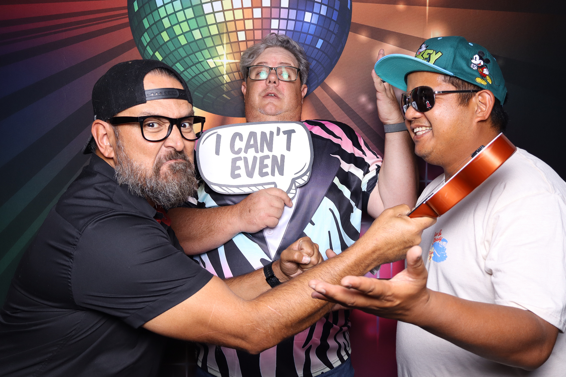 Friends having fun with props at a 50th birthday