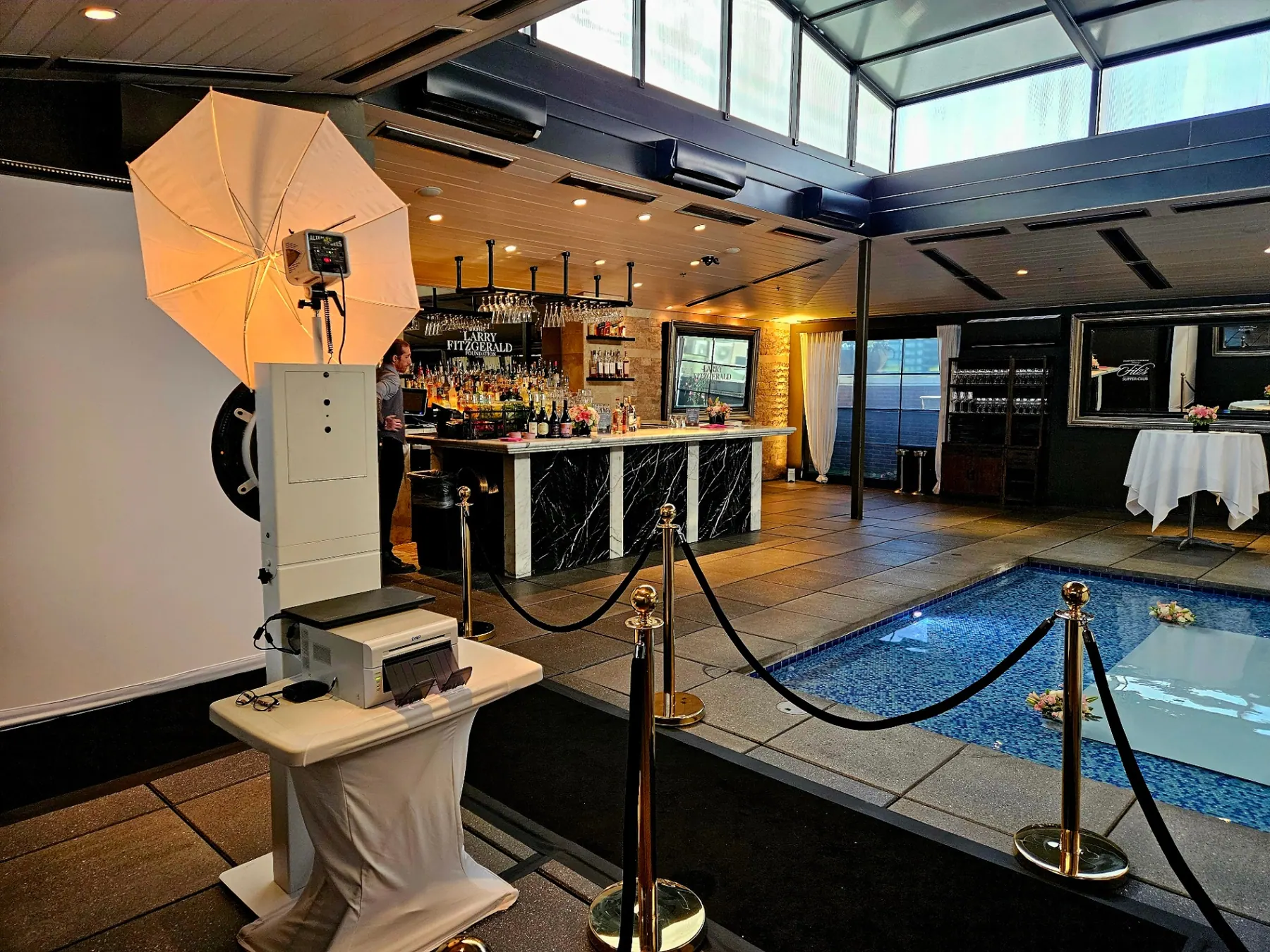 Elegant VIP arrival experience with stanchions, professional lighting, and a polished photo booth presentation