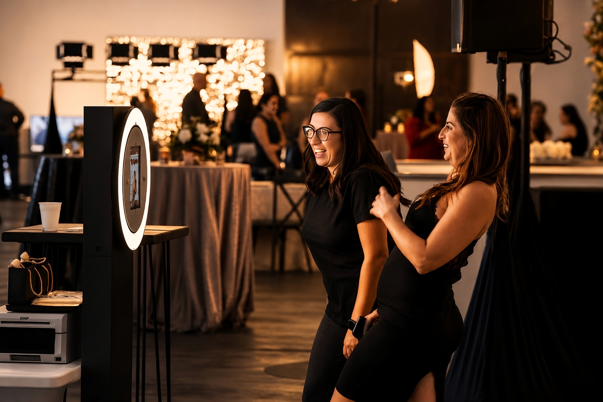 Two guests enjoying a ring light photo booth at an elegant event